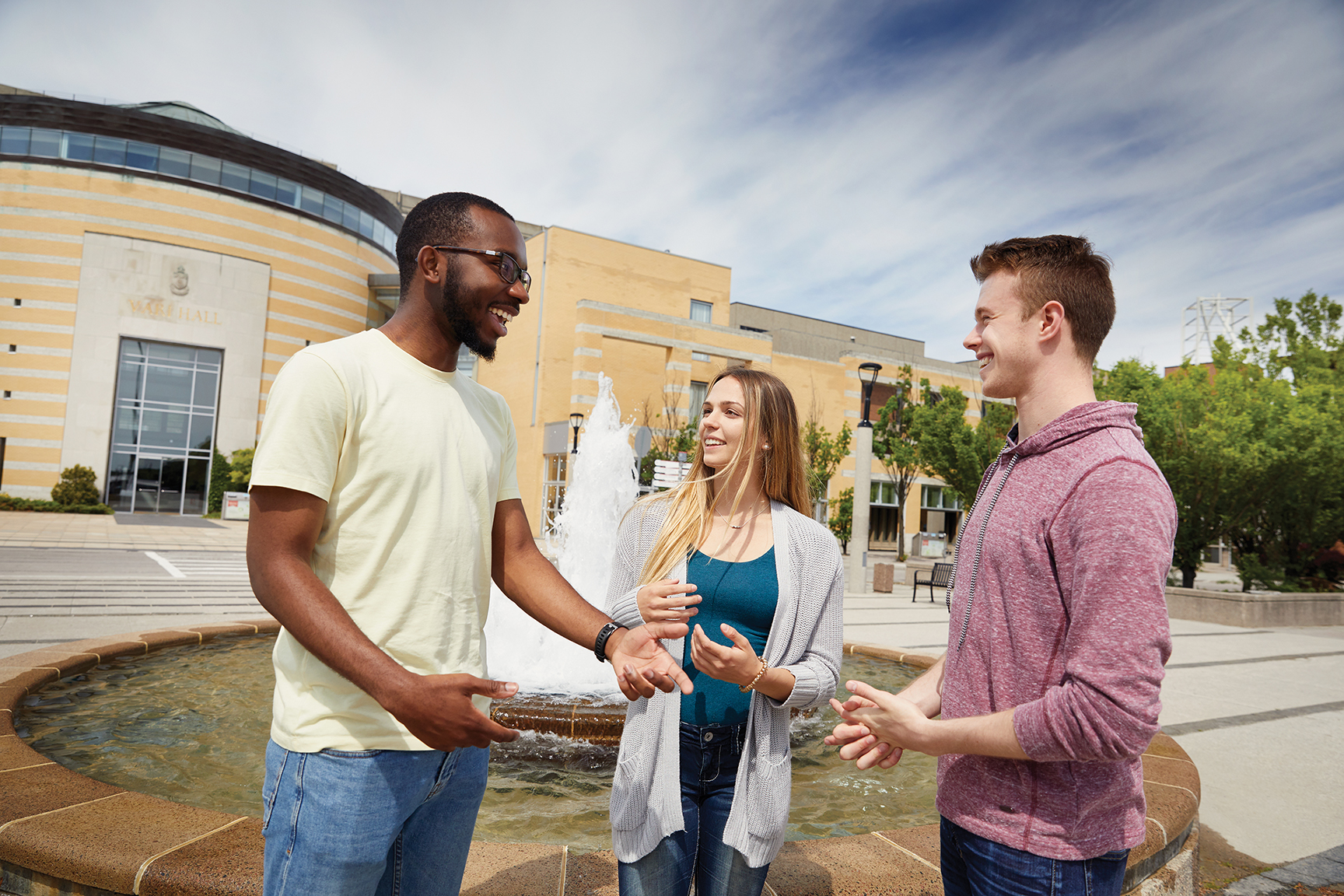 Three students talking outside Vari Hall