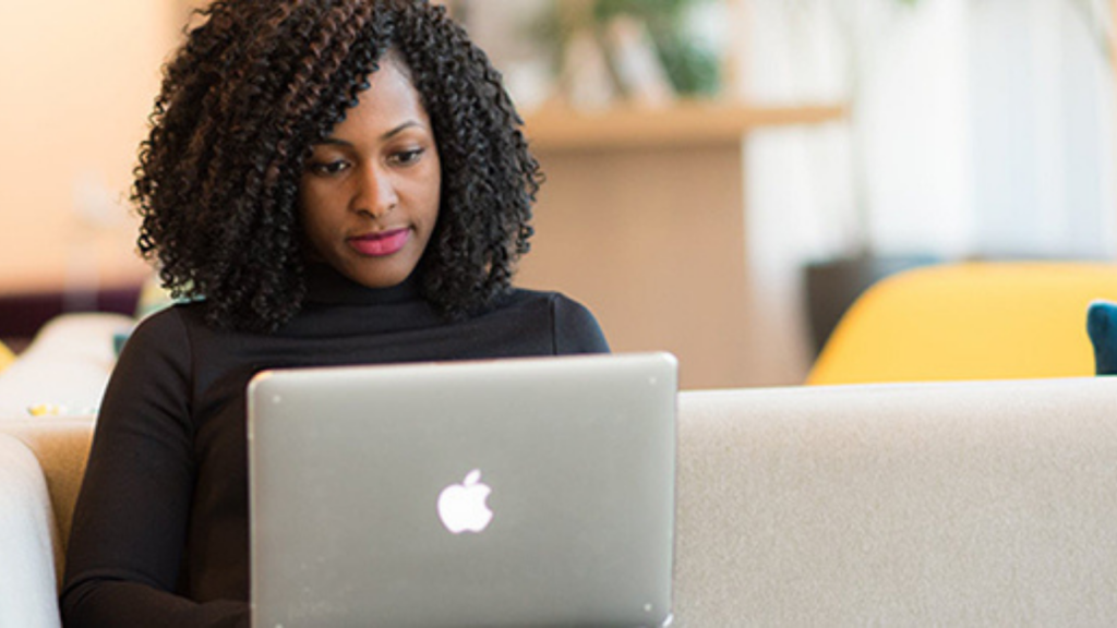 A black women working on a laptop 