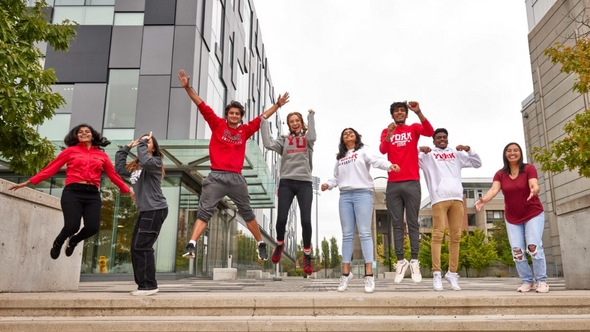 Group of York University students jumping in front of Life Sciences Building
