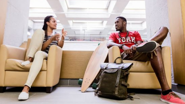 two students sitting on chairs