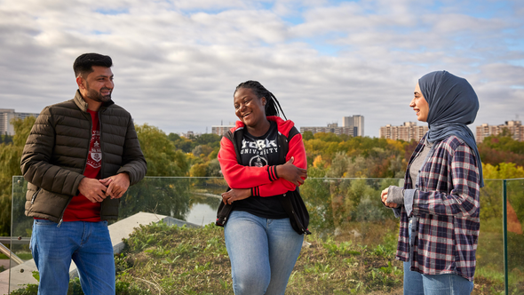 Three diverse students standing outside at York University