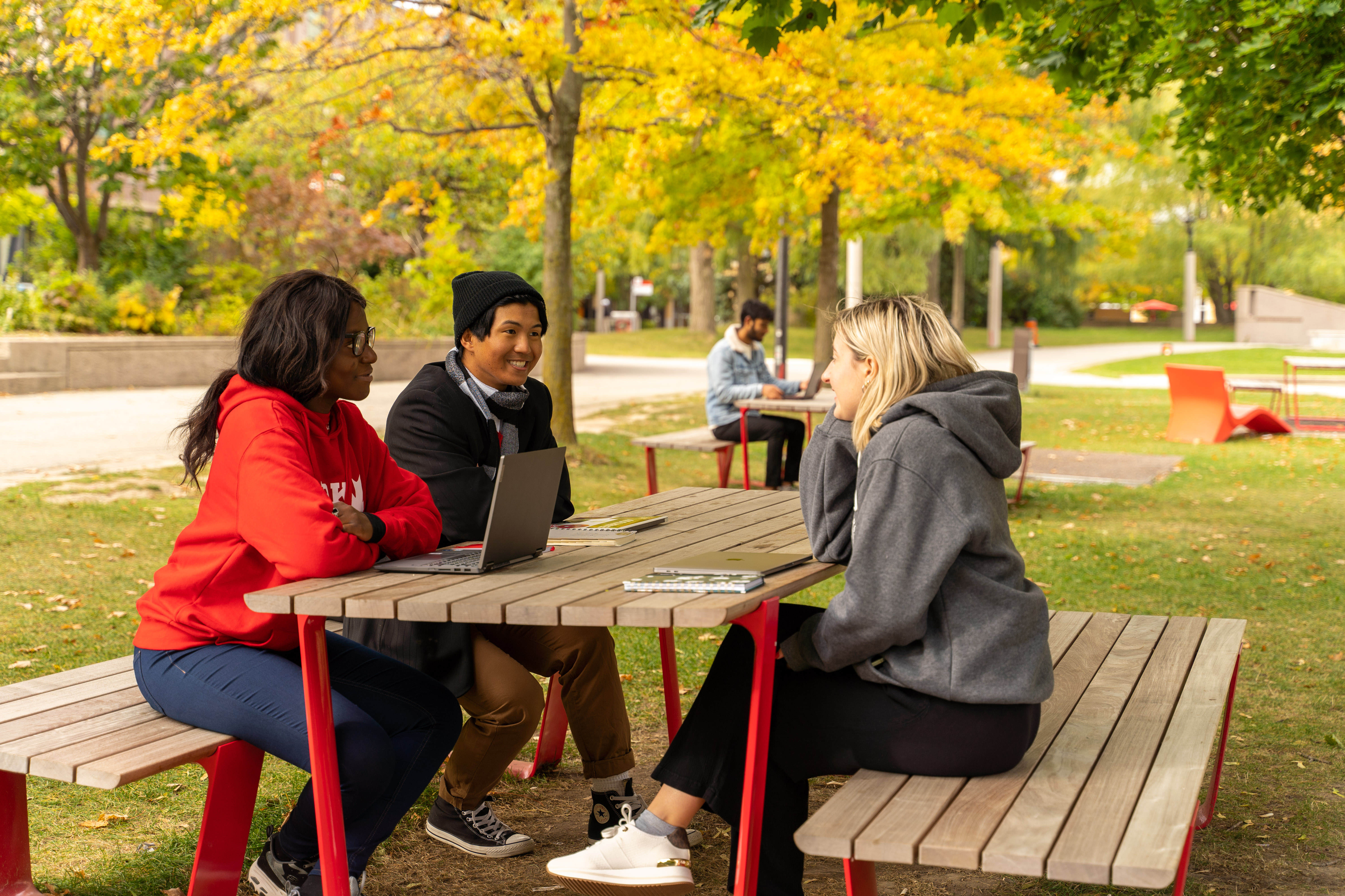 students sitting on a table outside