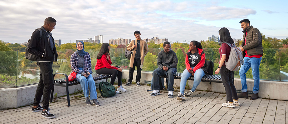 Group of students chatting on the Bergeron Building rooftop patio