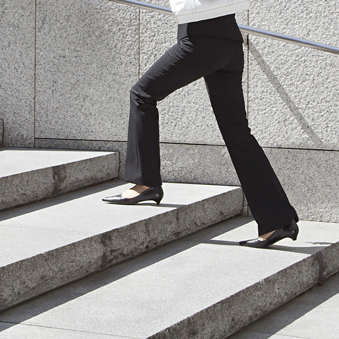 Image of a woman walking up the stairs