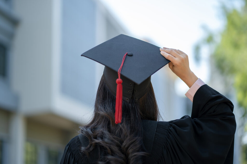 Girl holding graduation cap 