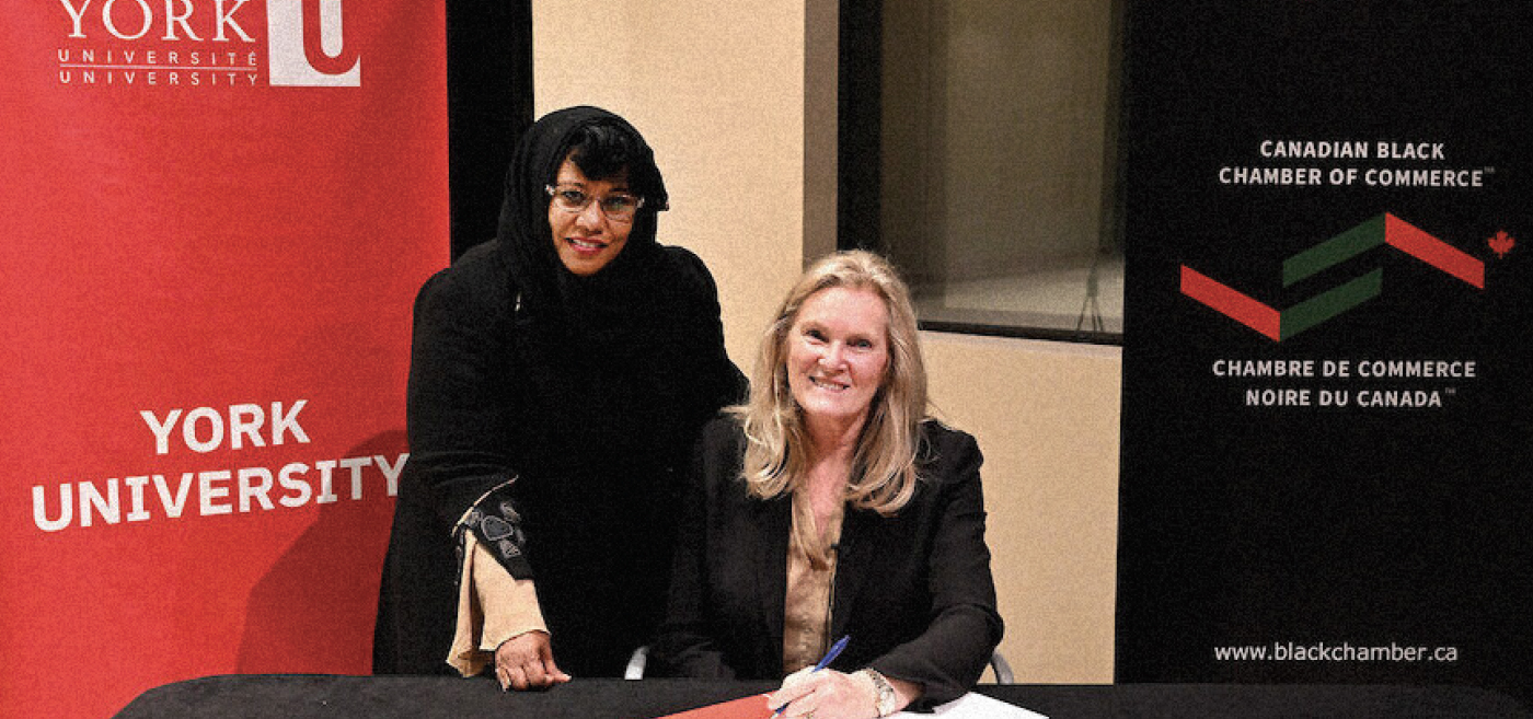 Dr. Jamila Aman, Executive Director of the Black Canadian Chamber of Commerce, and York University President and Vice-Chancellor Rhonda Lenton, sign the MOU