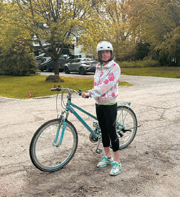 Woman standing by bicycle