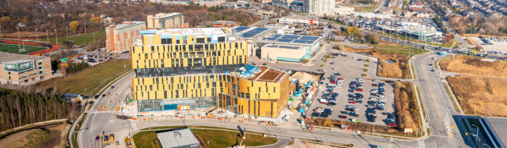 A photo of the Markham Campus, an incomplete building sorrounded by roads and construction machinery; a clear construction site.