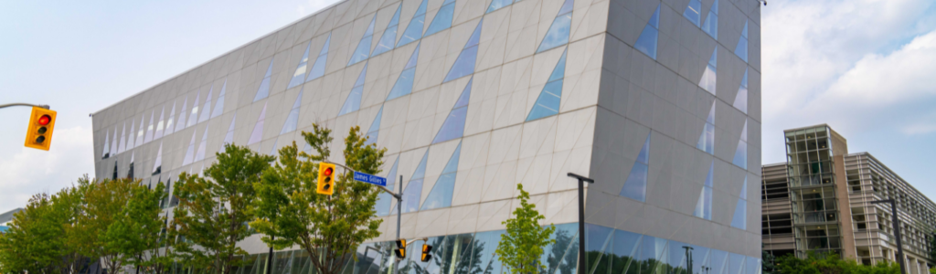 An image of the School of continuing Studies Building at York University, a tolted building with glass on all sides