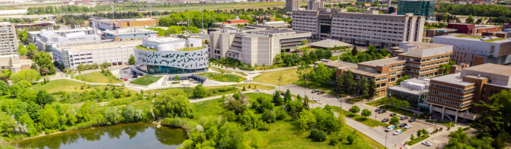 A aerial shot of the York University Keele campus featuring the Bergeron Building and lake with greenery