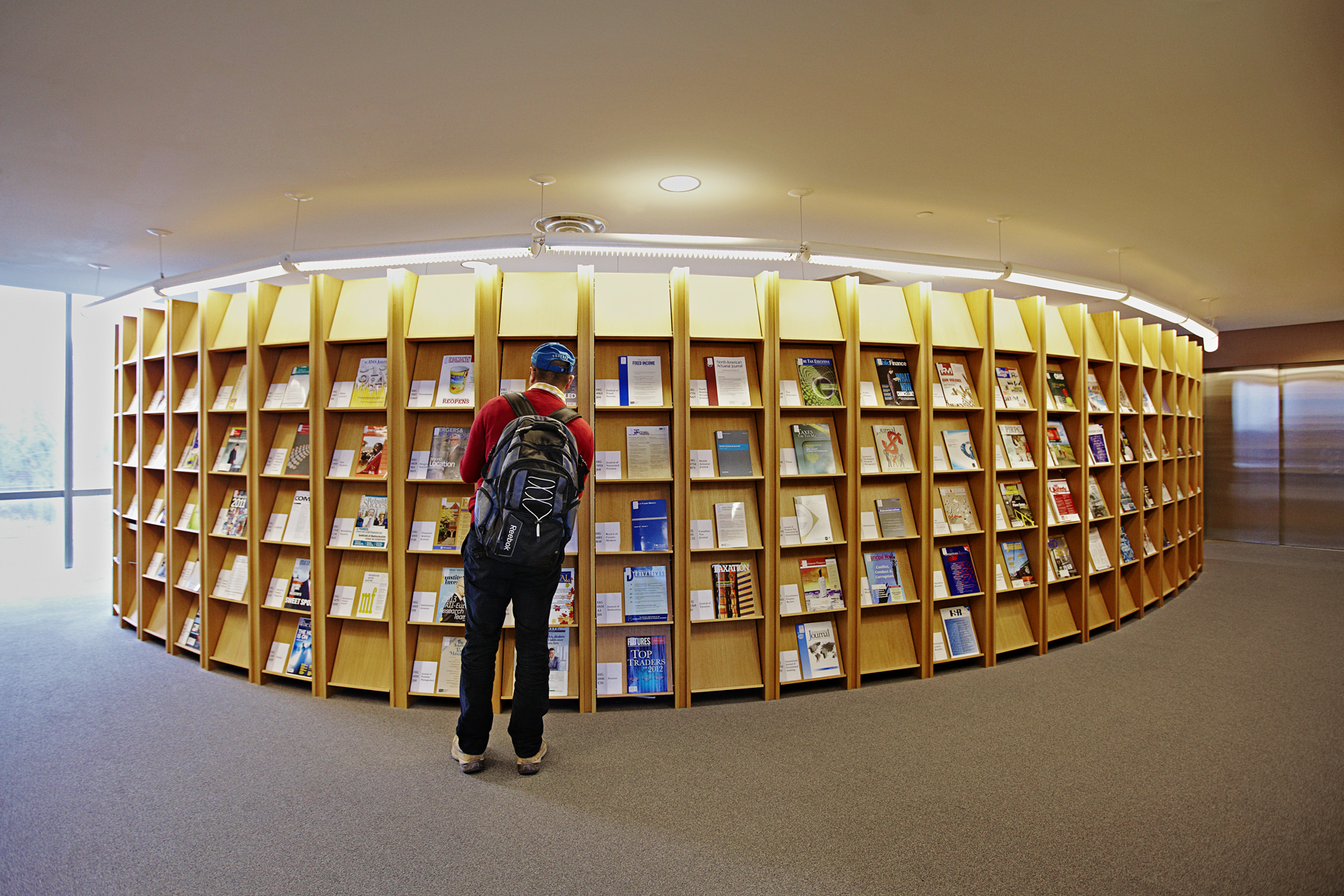 male student looking at journal display in the York U library