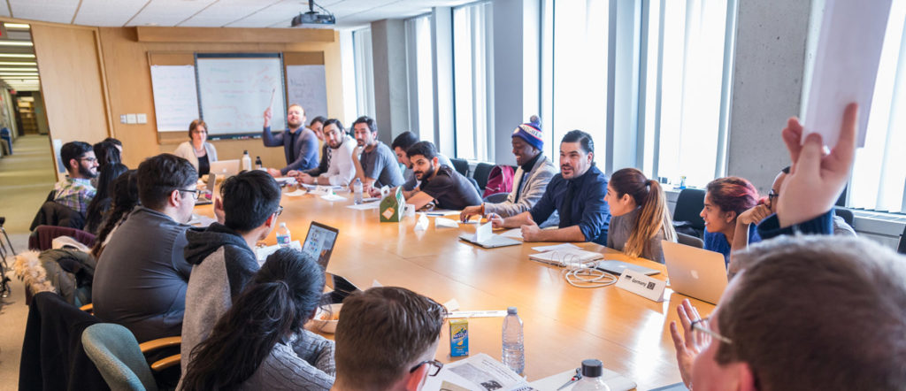 Students discussing and having a meeting at a conference table.