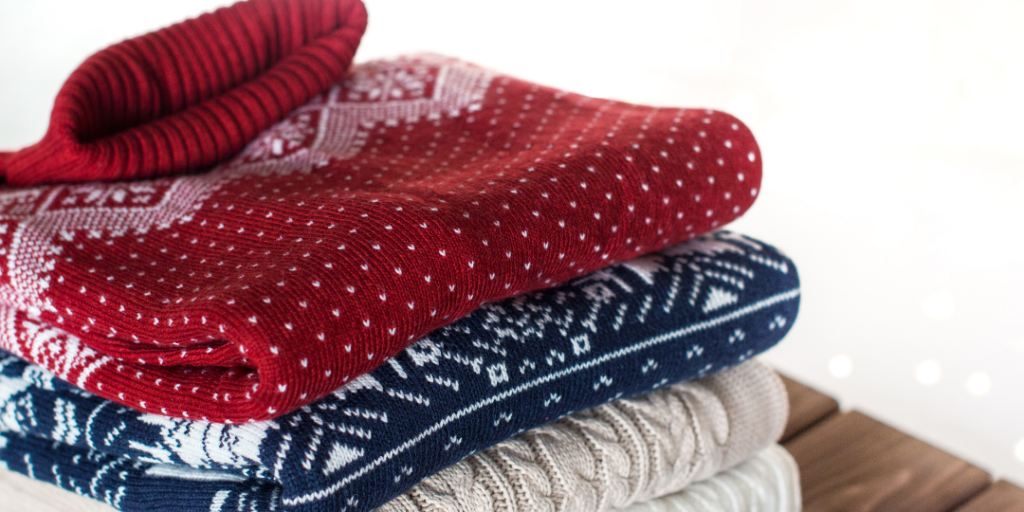 Knitted sweaters folded and stacked together