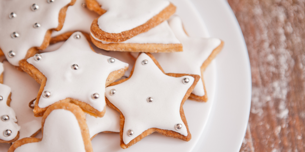 Star-shaped sugar cookies with white frosting on top