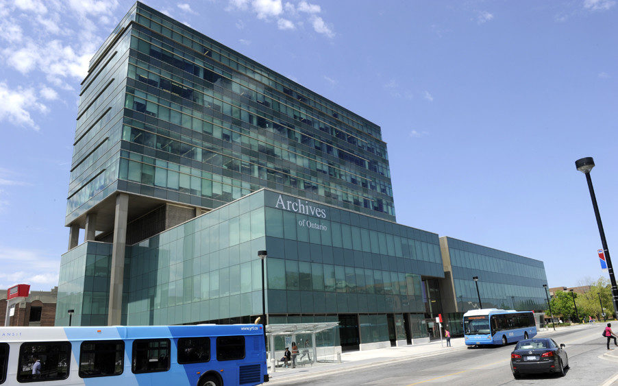 A large glass building in front of a blue sky