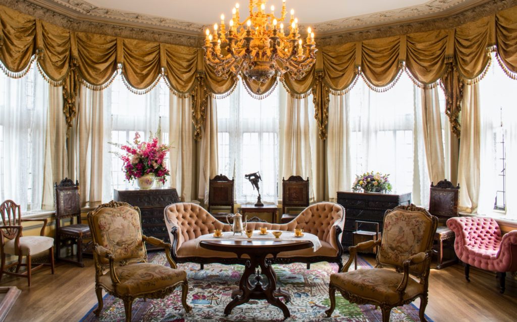 Formal sitting room with antique furniture focused around tea service on table