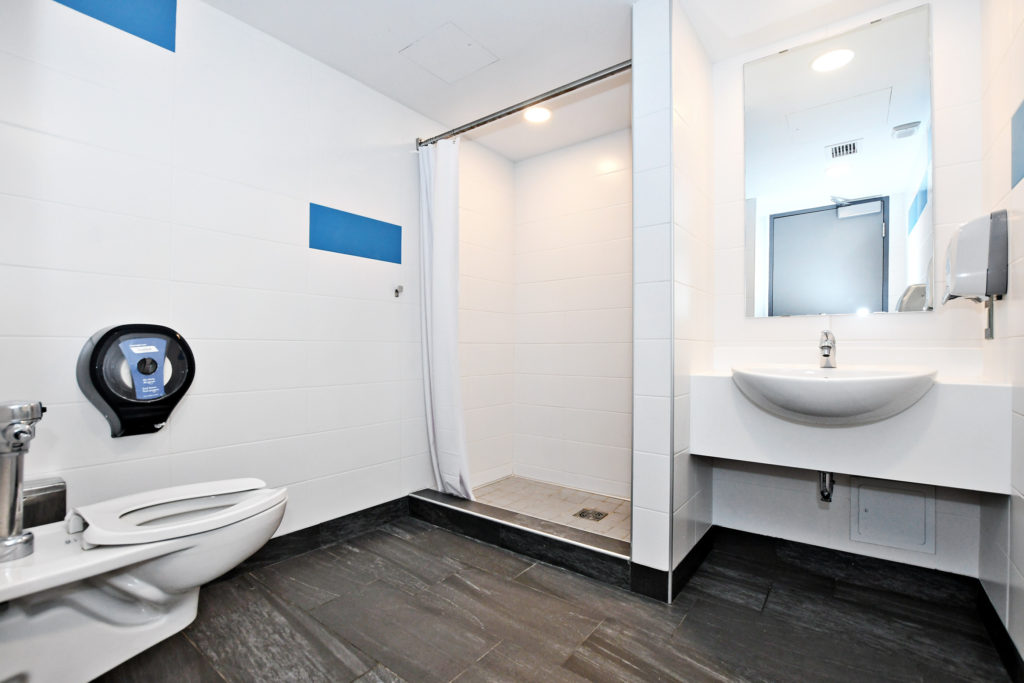 Interior of Tatham Hall semi-private washroom showing toilet, shower, sink.