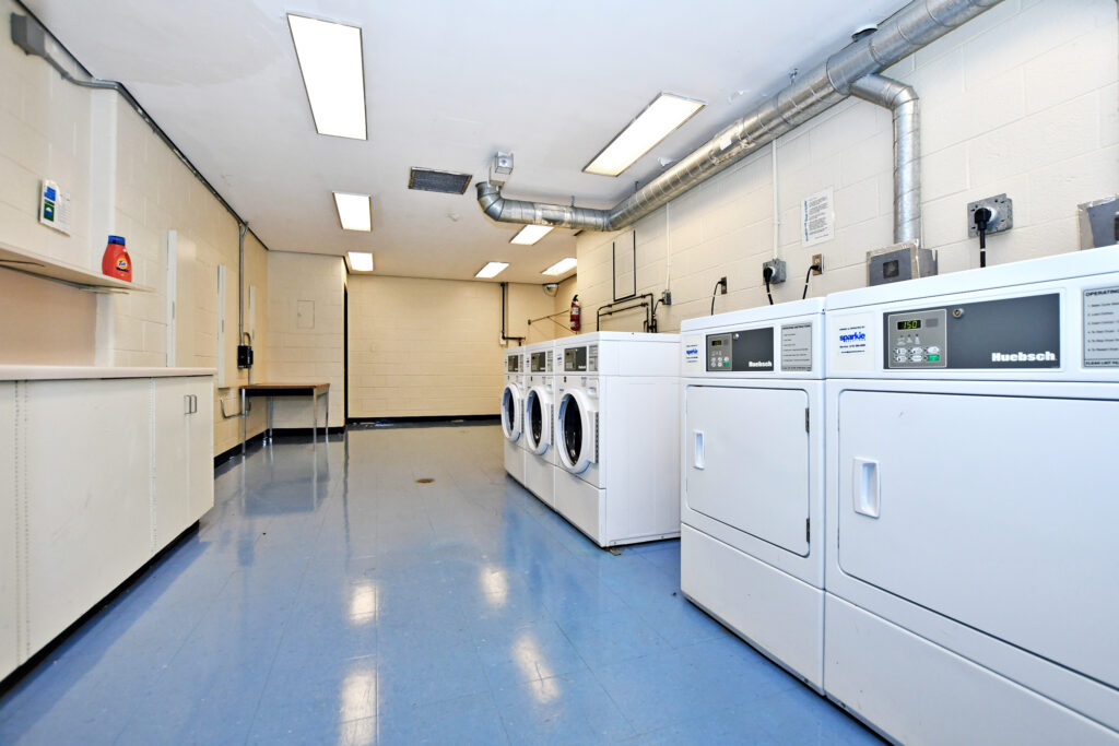 Vanier Residence laundry room showing 3 washers and 2 dryers/