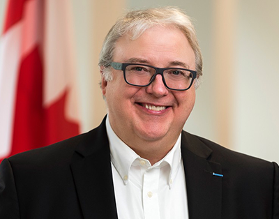Image of François Boileau with Canada flag in the background