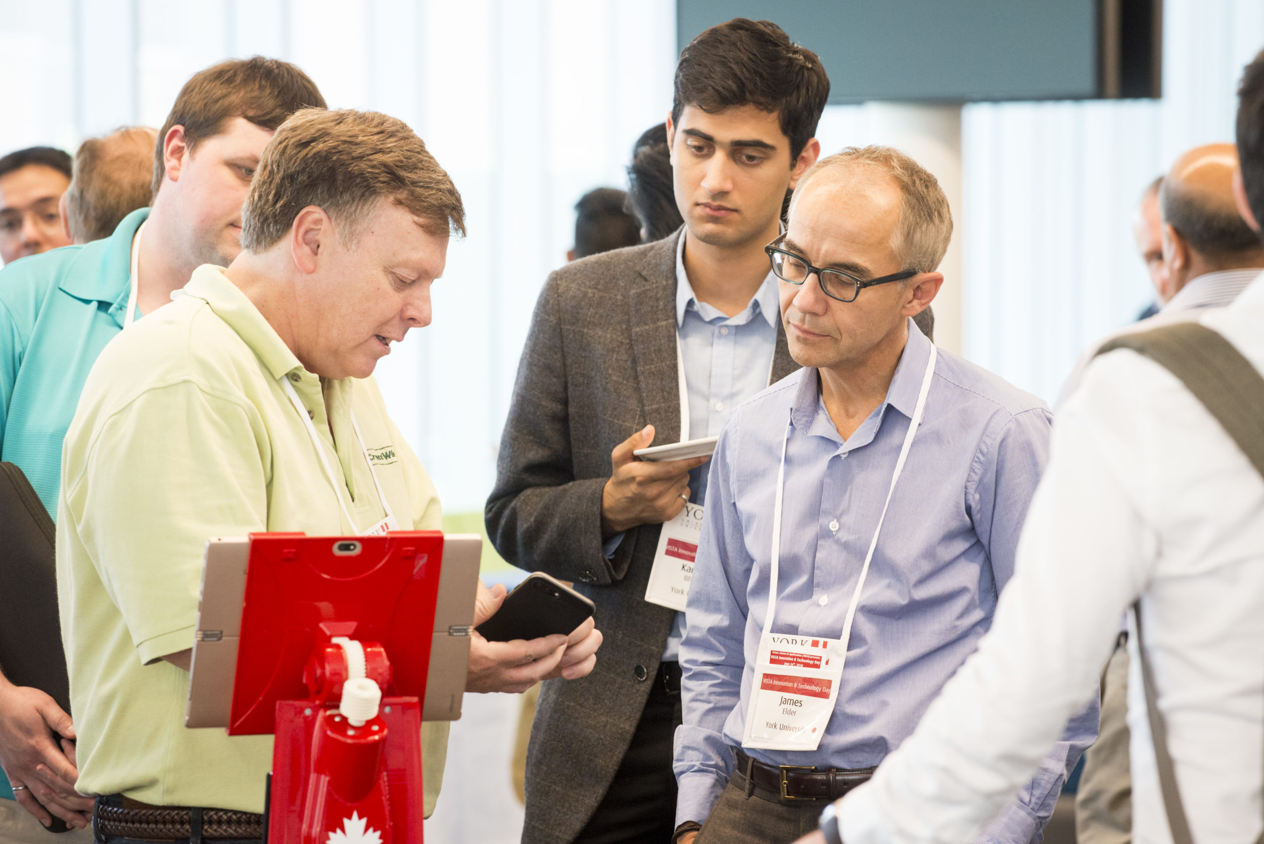 Person shows another person their phone at a conference