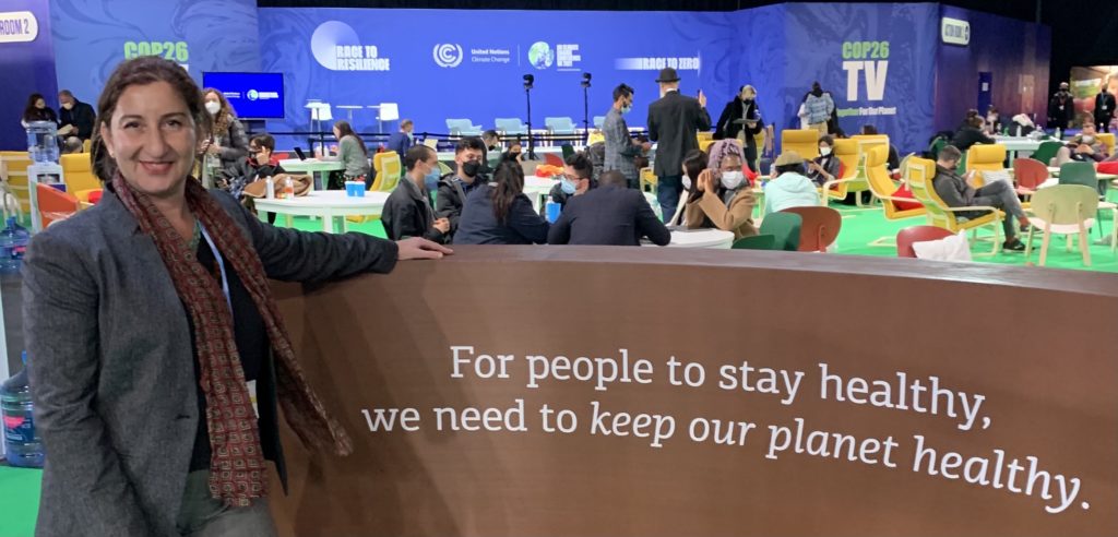 Idil Boran at the COP26 conference in front of a banner