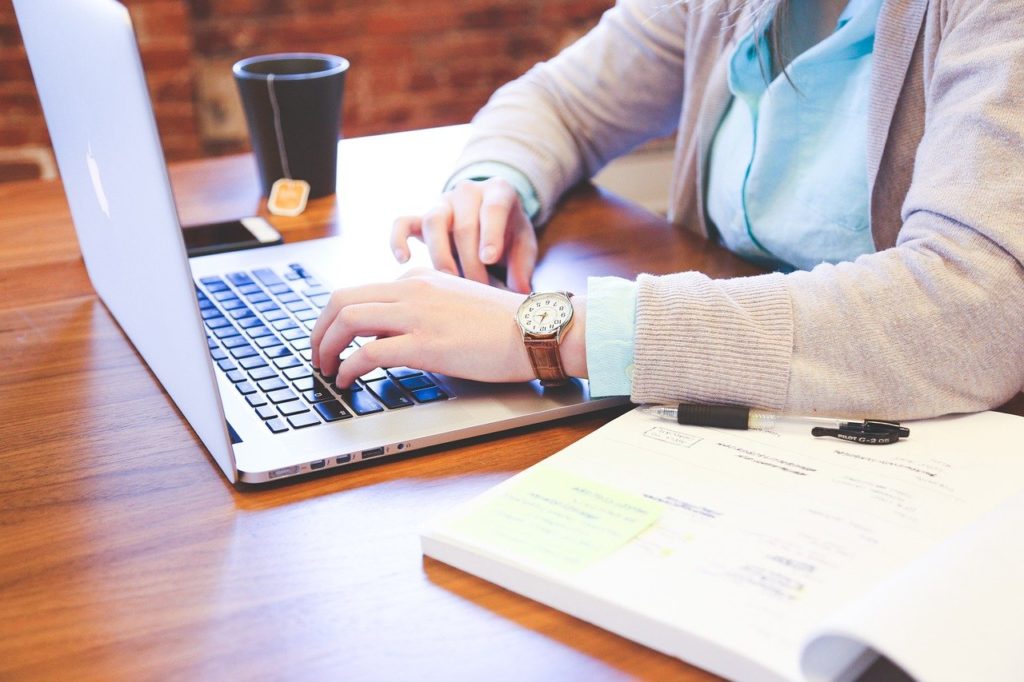 An individual working on a laptop