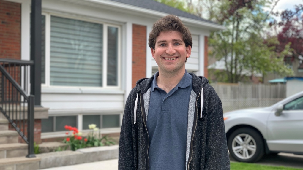 Jonathan Clodman standing outside of a house in Toronto.