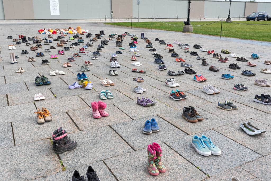 Photos show memorial around Centennial Flame at Parliament Hill to honour the lives of 215 indigenous children whose remains were found in a mass grave in Kamloops, BC, Canada.