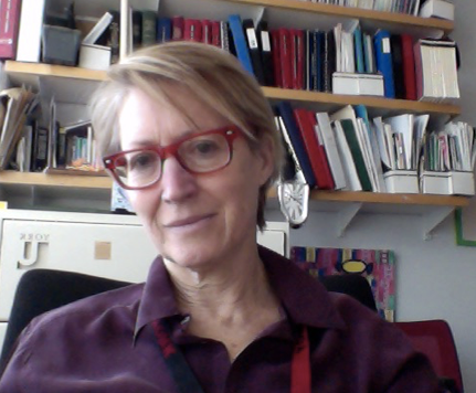 Professor Heather Lotherington sitting in her office in front of a bookshelf.