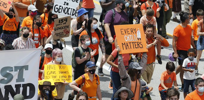 Protesters march to Parliament Hill in Ottawa in response to the discovery of unmarked Indigenous graves at residential schools on July 1, 2021. 