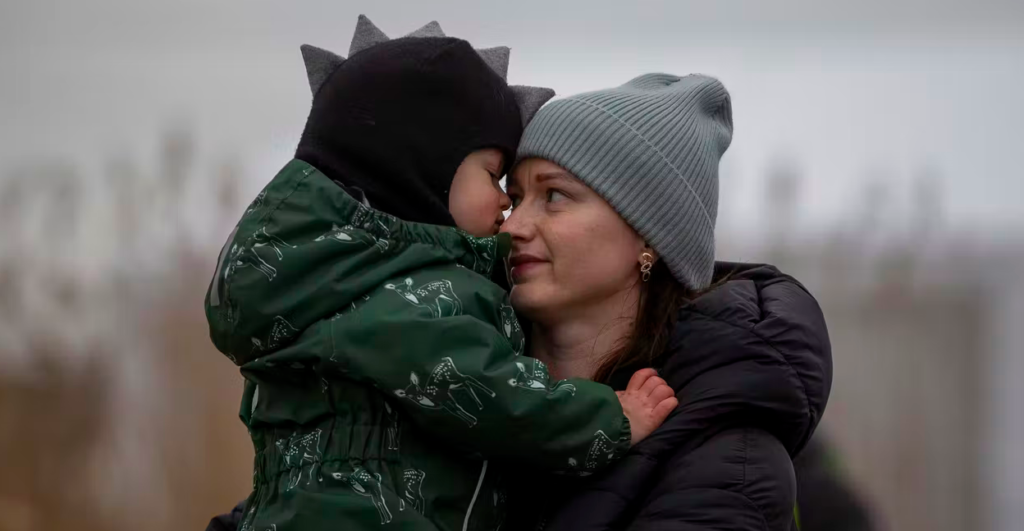 A woman and son arrive at the border crossing between Ukraine and Poland. (AP Photo/Visar Kryeziu)
