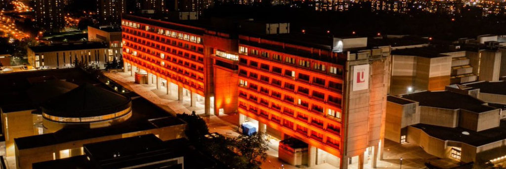 image of Ross Building on York University's Keele campus at night lit in orange for the National Day for Truth and Reconciliation