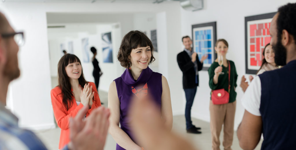 Young woman working at art gallery launch event