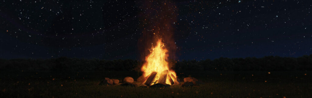 bond fire burning below a beautiful night sky full of stars