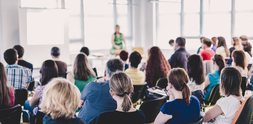 people at a conference listening to a speaker