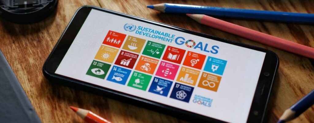 tablet on desk with image of the UN SDGs on the screen