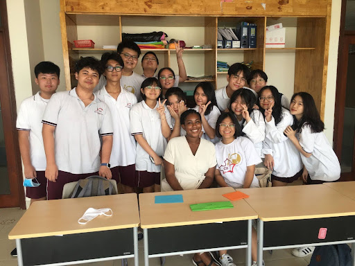 Victoria Ennis (pictured in centre) with a class of high-school aged male adn female students in Vietnam