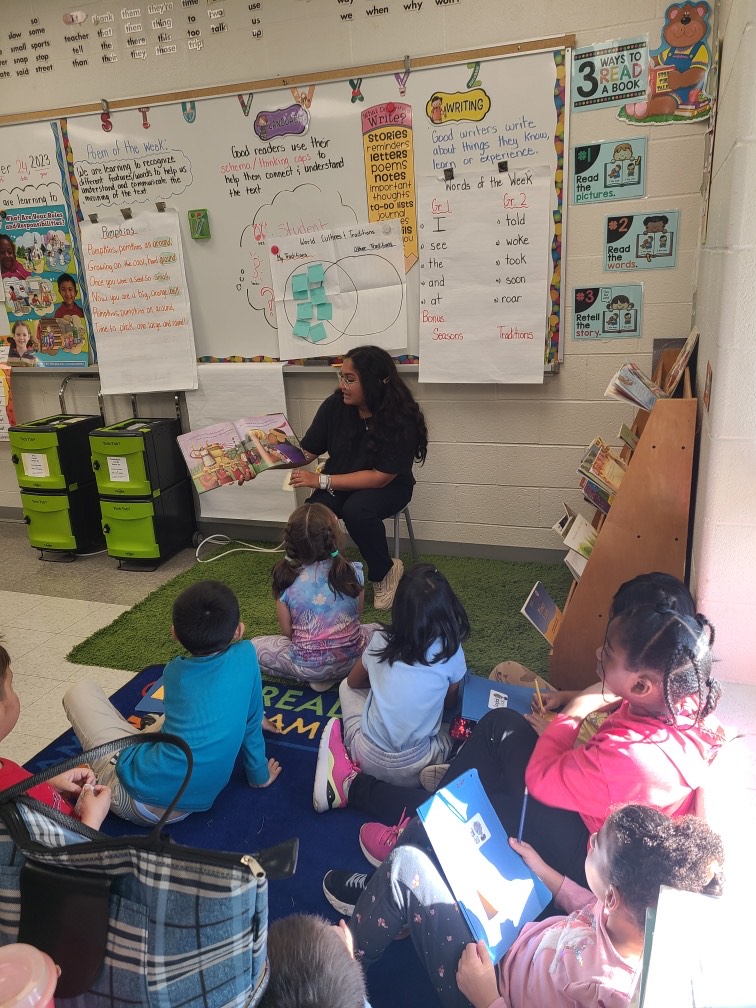 Chloe Furtado reading to grade 4 students at St. Philips Catholic Elementary School