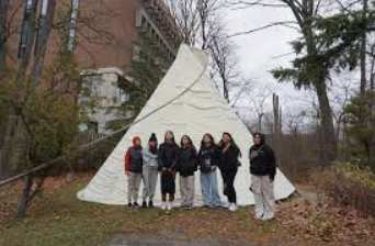 The girls in front of the University Teepee at Skennen'ko:wa Gamig