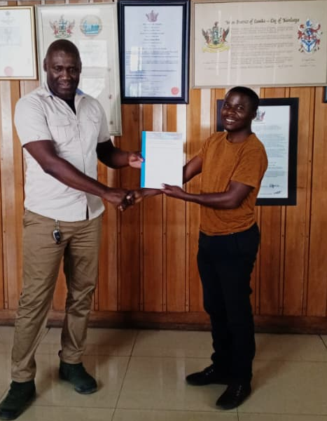 a certificate handing over to a woman from a man