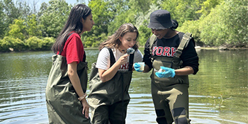 A group of EUC Students collecting sample in the middle of a stream