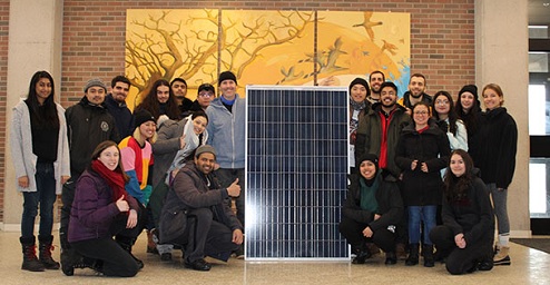 Picture of a group of people at a solar panel tr4aining