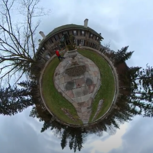 image image centered on the tiles in front of the Glendon Manor under a grey sky. The 360 effect gives the impression of a tiny circular world surrounded by sky in all directions.