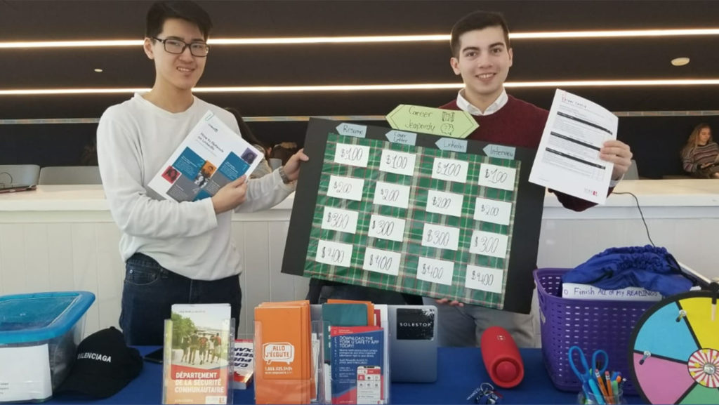 Two students at a display table