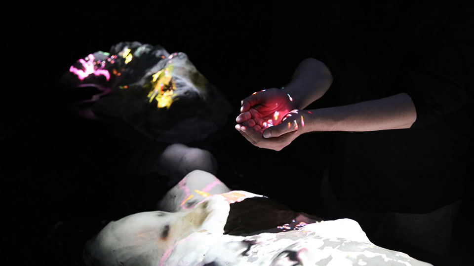 image of lights projected onto cupped hands