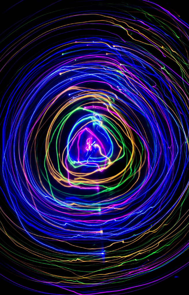 centre partial image of multi-coloured neon lights forming a circle