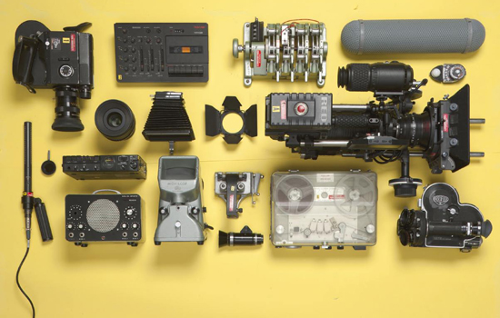 photo of an assortment of film equipment arranged on a yellow background