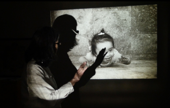 image of a woman casting a shadow on a projected image of a child