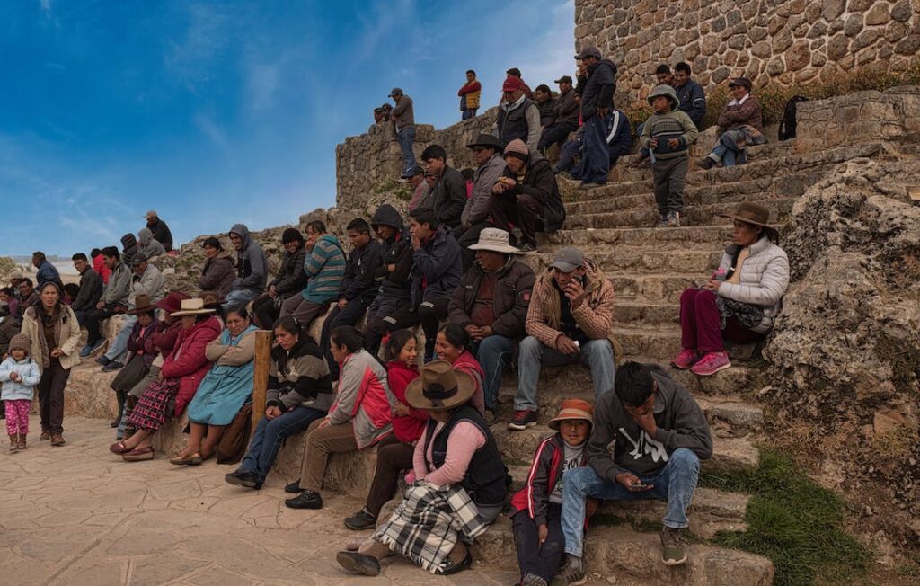 large group of people sitting on stone steps