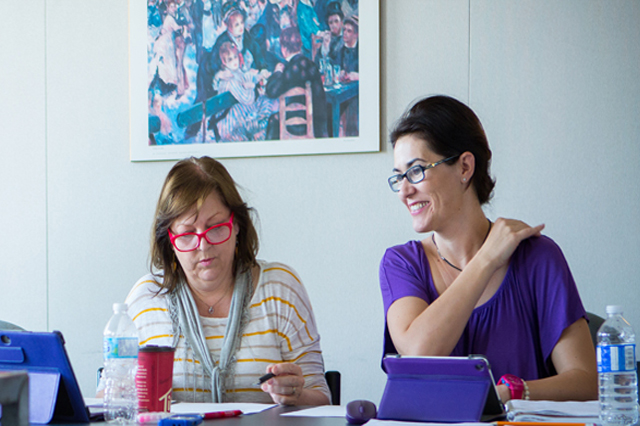 Photograph of a faculty member conversing with students